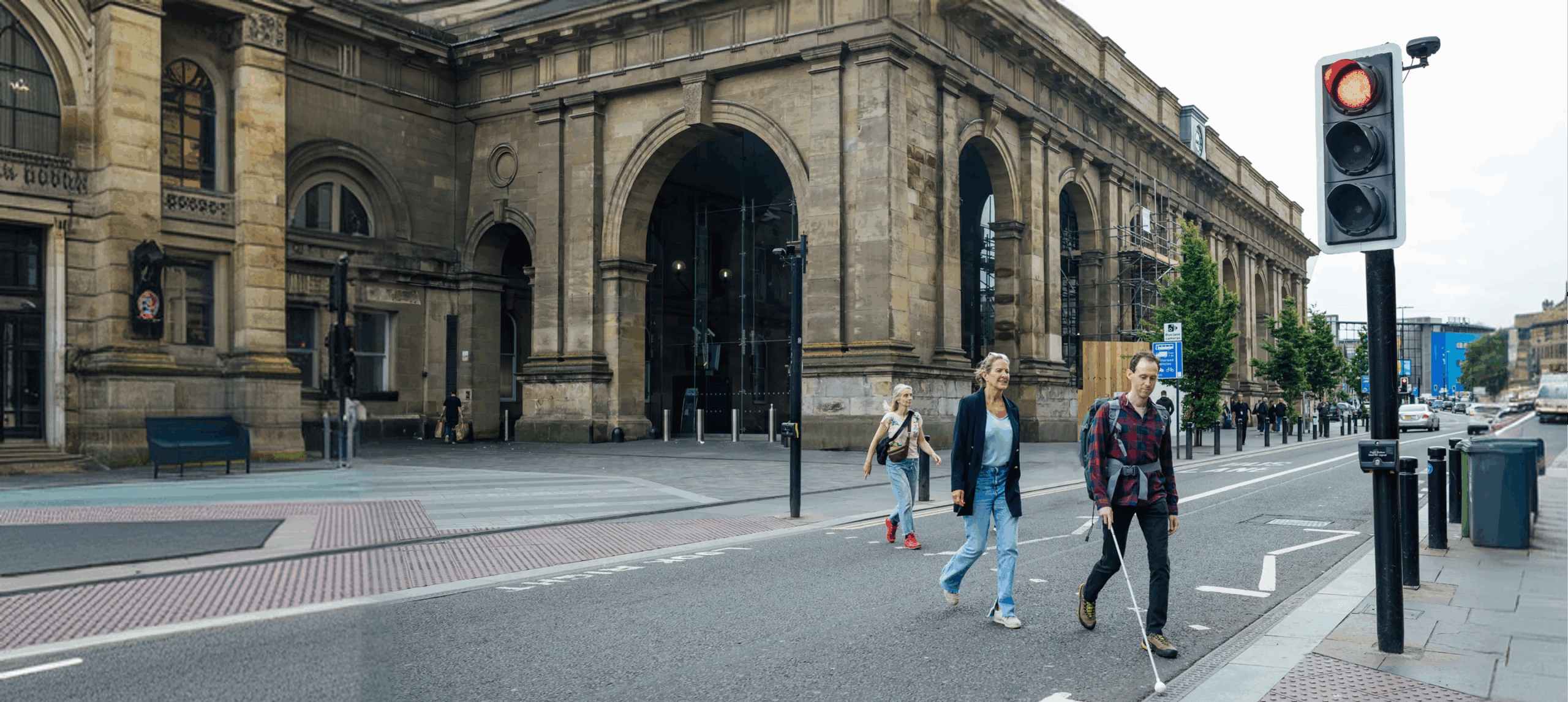 People crossing street near historic building