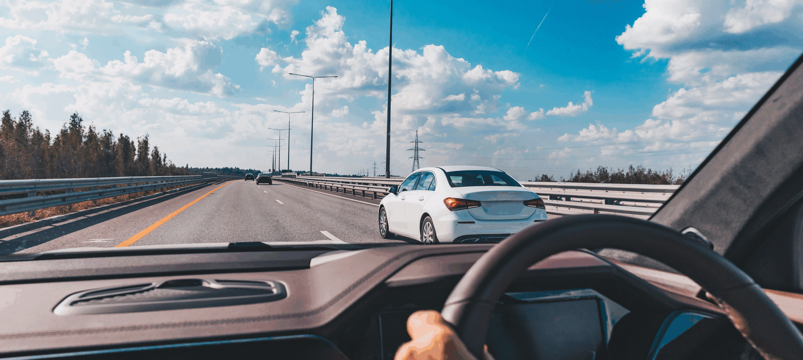 Car on open road, clear sky