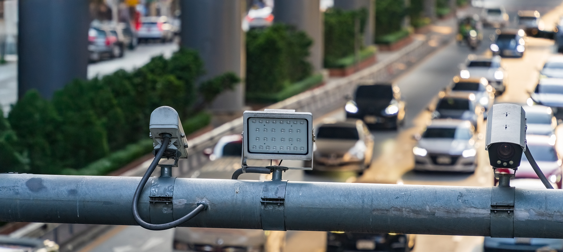 Roadway security cameras on a bustling street