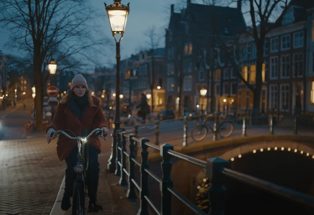 Cyclist riding through evening cityscape
