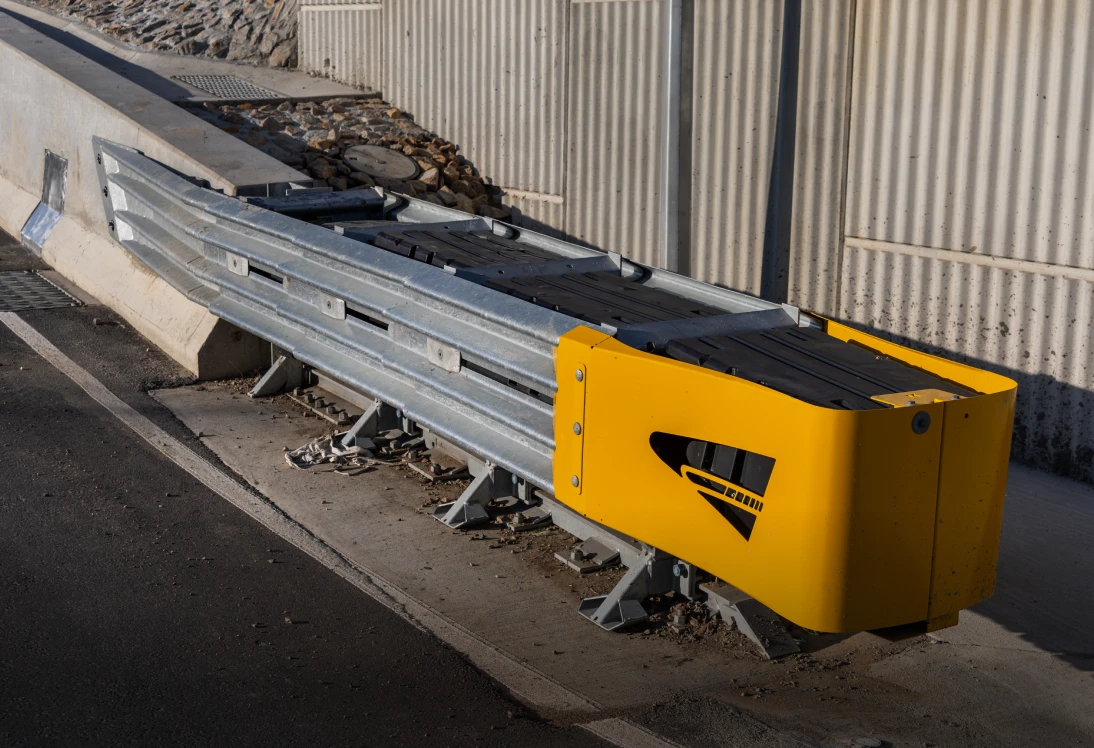 Metal road barrier with yellow end cap